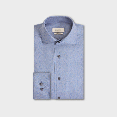 Light blue long-sleeve Bugatchi Devon Foliage Print Sport Shirt (KF9423K80) with a subtle leafy pattern, folded neatly. The Bugatchi brand label is visible on the inner collar. This wrinkle-resistant shirt blends style and practicality for a polished look all day.