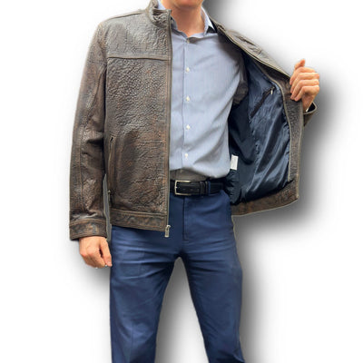 A man in a blue shirt and navy pants displays the inner lining of the Missani Big & Tall Leather Jacket 394167 by holding one side of this premium Missani jacket open.