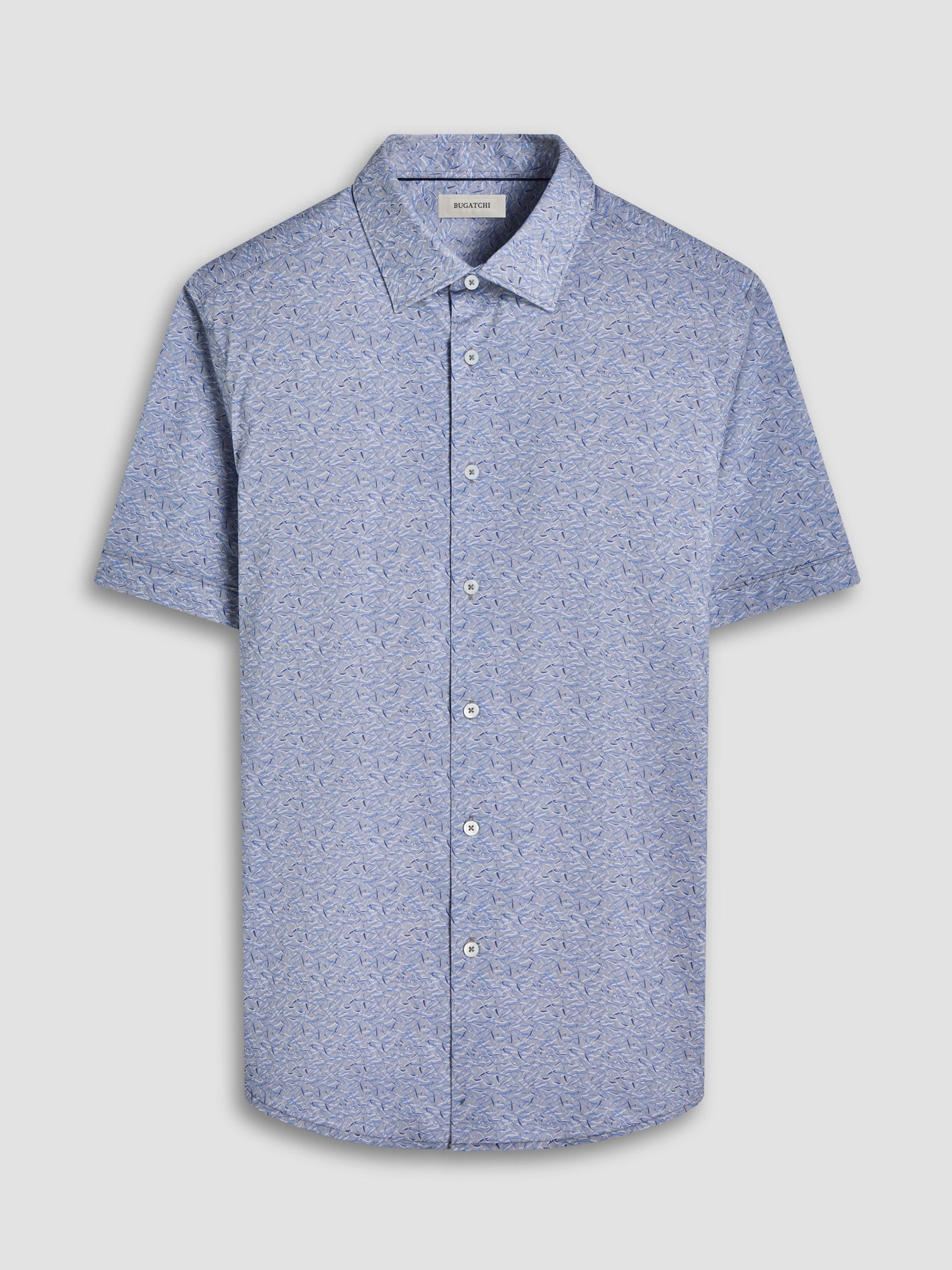 The Bugatchi SS Miles GF9111F40 Sand by Bugatchi is a light blue short-sleeve button-up shirt featuring a subtle abstract pattern, spread collar, and white buttons, crafted from premium Italian-inspired fabrics and shown on a plain background.