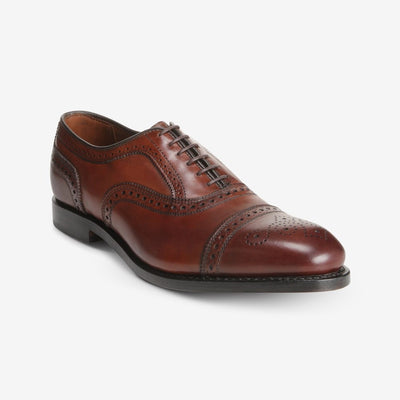 Allen Edmonds Strand oxford dress shoe in brown calfskin, featuring classic brogue details and laces from Allen Edmonds, shown on a white background.