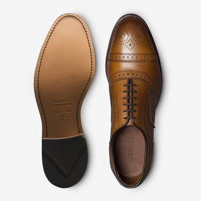Top-down view of the Allen Edmonds Strand oxford by Allen Edmonds in tan calfskin, featuring brogue details on the leather upper, a leather sole, and dark brown laces.