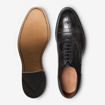 A pair of Allen Edmonds Strand black calfskin oxford dress shoes, displayed from top and bottom views on a white background.