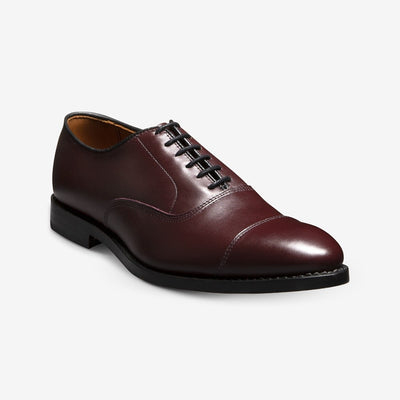 The Allen Edmonds Park Avenue by Allen Edmonds is a single black oxford dress shoe crafted from premium European calfskin with black laces, a low black heel, and Goodyear welt construction, displayed on a white background.