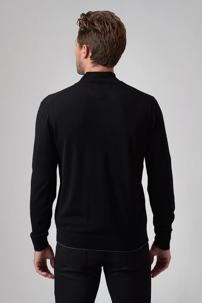 A man faces away from the camera, wearing a black Raffi Merino Zip Mock HWC19398-Z sweater and black pants against a plain light background.