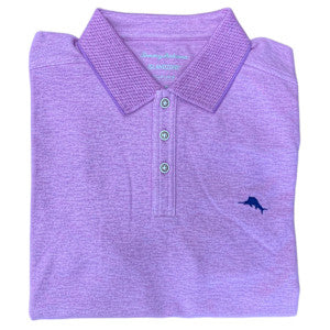 A neatly folded light purple Tommy Bahama Emfielder Polo Big & Tall shirt features three buttons and a small blue marlin logo on the chest, crafted from moisture-wicking fabric for lasting comfort.