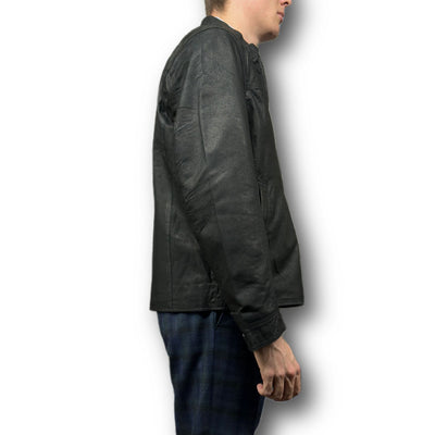 A person in profile wears the Missani Vintage Leather Jacket 392794 with blue plaid pants against a white background, highlighting the classic style of this Missani jacket.