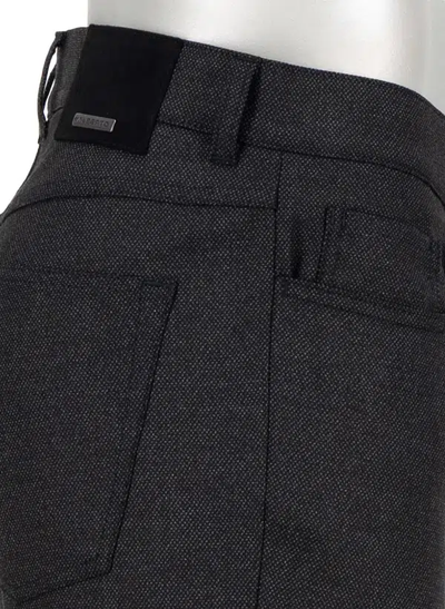 Close-up side view of the Alberto Pipe Melange Birdseye Pant 1638, featuring dark textured melange wool, belt loops, a back pocket, and a small metal Alberto brand tag near the waistband.