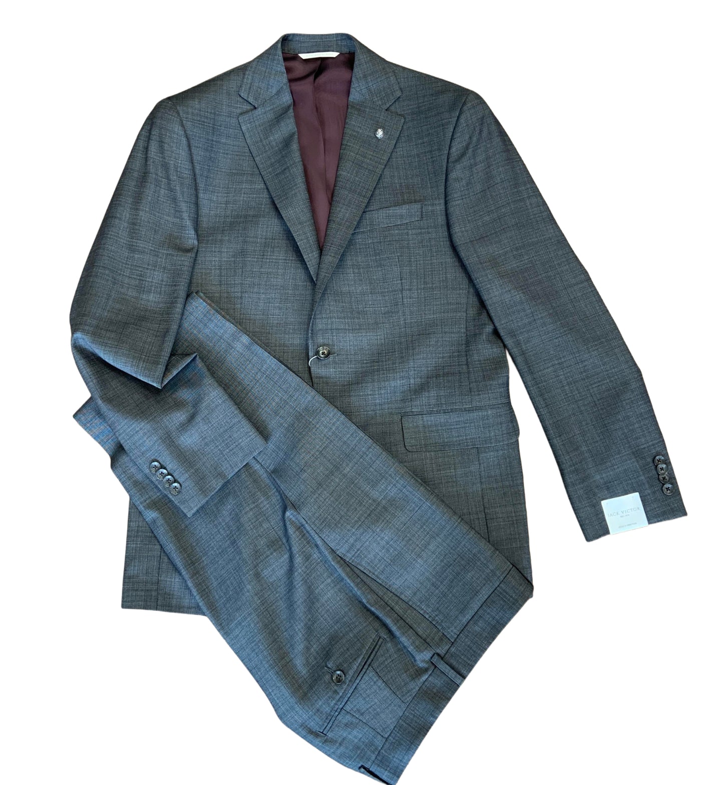 The Jack Victor Gibson Suit 3251600 is a gray two-piece men's suit in premium wool, featuring a notched lapel jacket and matching modern-fit trousers by Jack Victor, displayed flat on a white background.