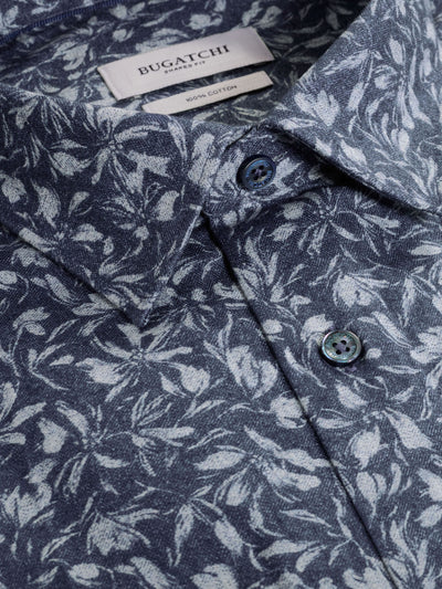 Close-up of the Bugatchi Julian Woven Sport Shirt HS3051L3S in blue, featuring a white leaf pattern, buttoned collar, and Bugatchi label.
