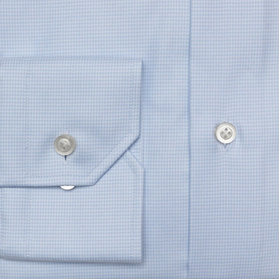 Close-up of the Hagen Houndstooth Dress Shirt MB8852450 by Hagen, featuring light blue premium cotton with a subtle check pattern, a buttoned pocket flap, and two white buttons—an essential for any formal wardrobe.