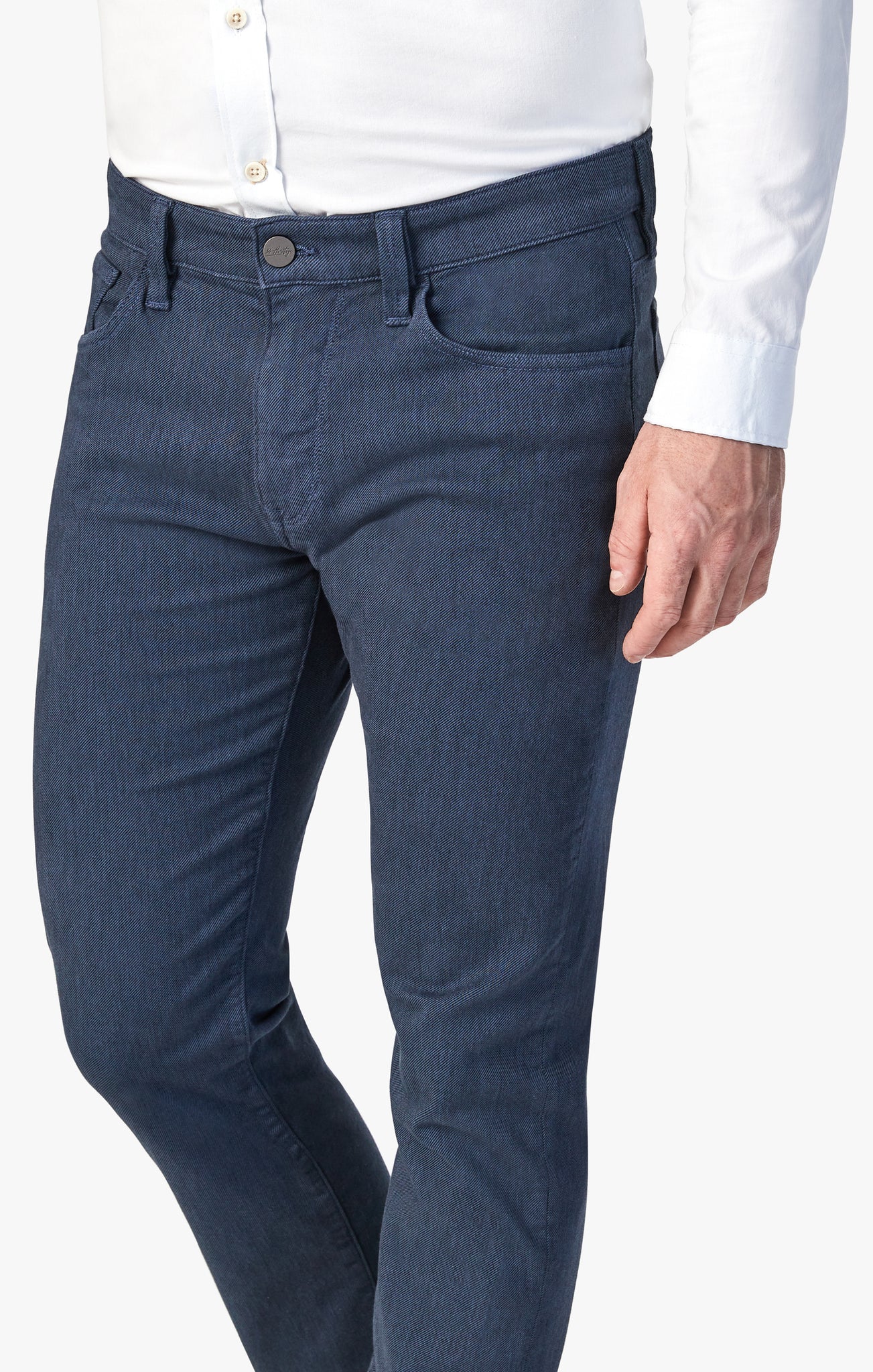 A person modeling 34 Heritage Courage Diagonal Pants in a coffee shade and straight fit, paired with a white button-up shirt, showcased from mid-torso to knee against a plain background.