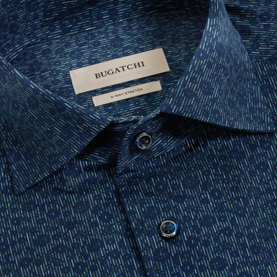 Close-up of a blue Bugatchi James Floral Sport Shirt KF9190K80, featuring a subtle linear pattern and two visible buttons, with the Bugatchi brand and 8-way stretch label visible inside the collar.