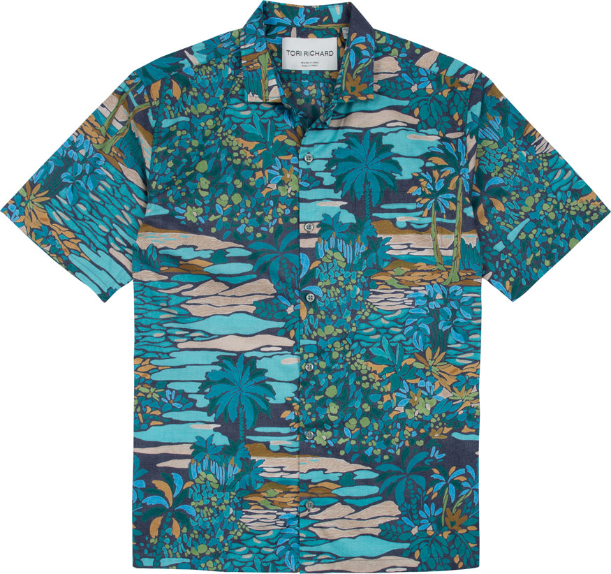 The Tori Richard Printed Cotton Opalescent Shirt 1956M0330 is a short-sleeved button-up featuring a blue, green, and brown tropical landscape print with palm trees and foliage.