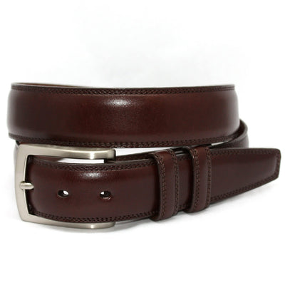 The Torino Italian Burnished Kipskin Leather Belt, in brown with a silver buckle, is shown rolled up against a white background. Made of premium kipskin leather by Torino.