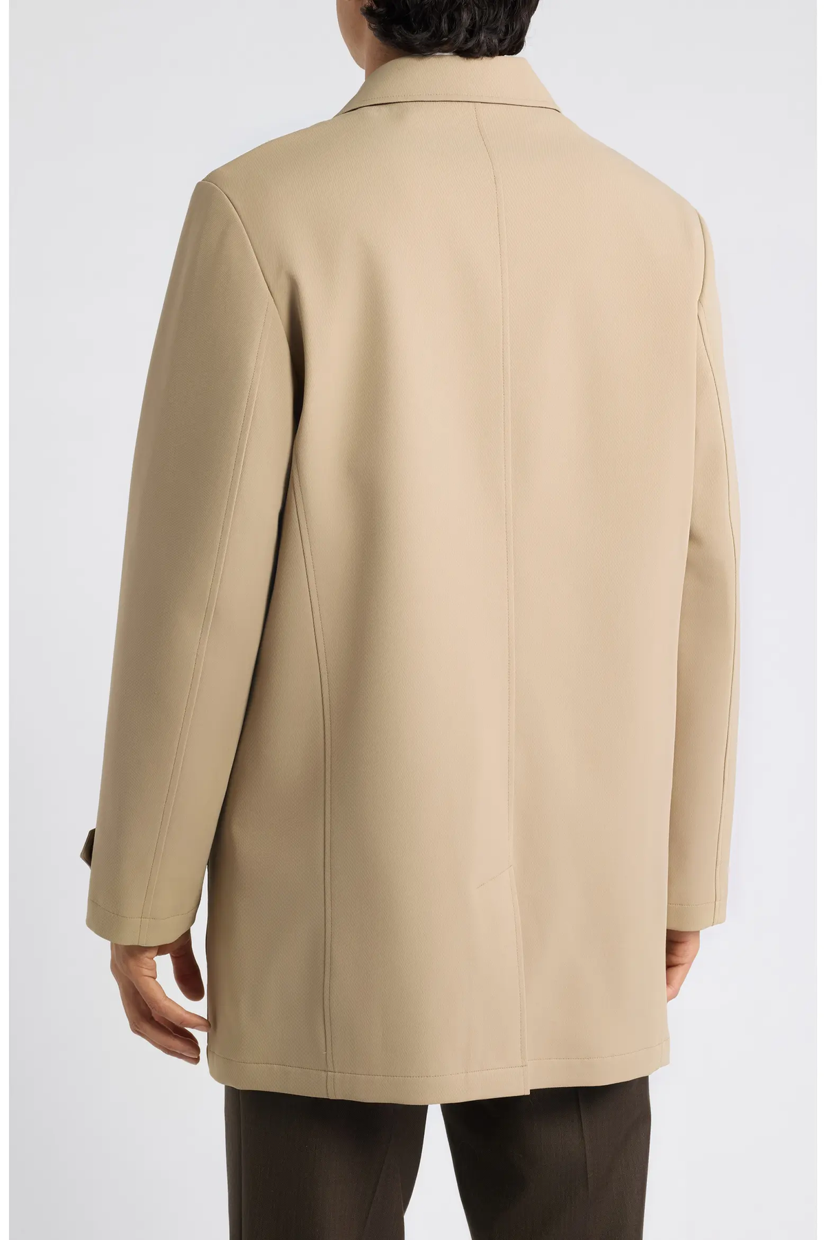 Back view of a person wearing a tan, mid-length Hart Schaffner Marx Milo Waterproof All-Weather Jacket.
