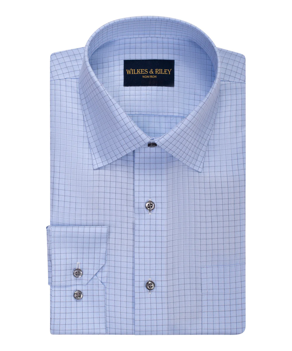 Folded light blue Wilkes & Riley Herringbone F5803 Supima cotton dress shirt with a grid pattern, spread collar, buttoned cuffs, and visible Wilkes & Riley label inside the collar.