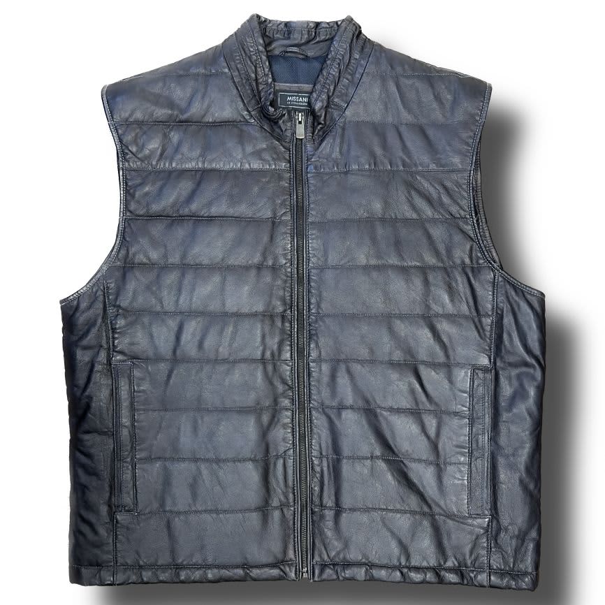 The Missani Leather Vest by Missani is a black, sleeveless vest made from Italian lambskin leather with a quilted design, front zipper, and two side pockets, shown on a white background.