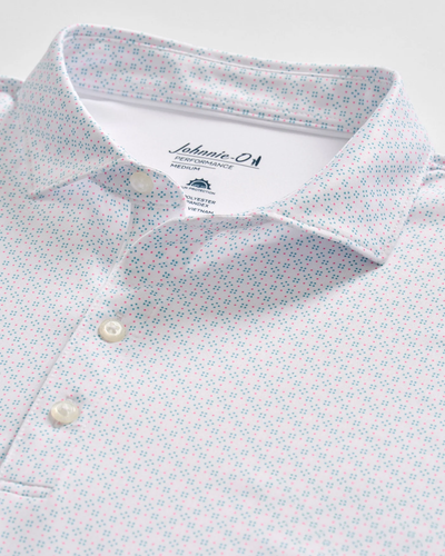 The Johnnie-O Torres Performance Big & Tall Polo is a light-colored casual shirt with a subtle blue and red geometric pattern, white buttons, and visible Johnnie-O branding on the inner collar.