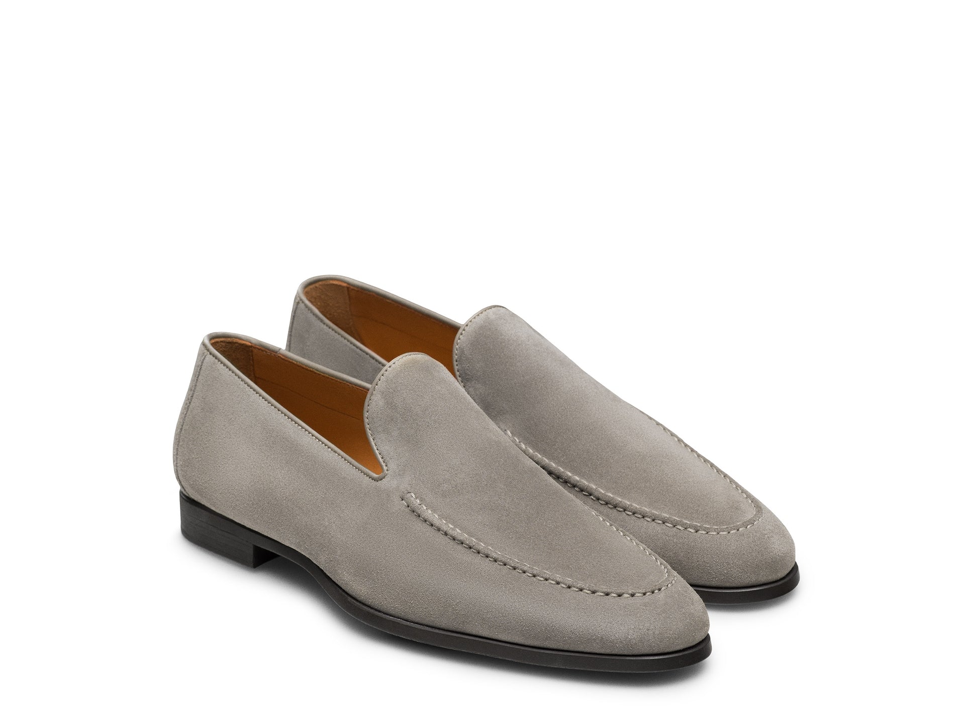 The Magnanni Lecera II Suede Loafer is a men's light grey suede shoe with a low black heel and tan interior lining, displayed on a white background.