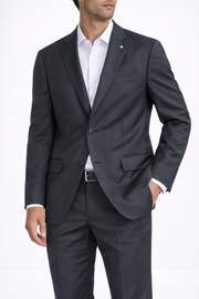 A man stands with one hand in his pocket, wearing the Hart Schaffner Marx Black Windowpane New York Suit 3210216, paired with a white dress shirt and black belt, against a plain white background.