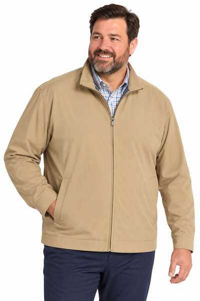 A man wearing a tan Hart Schaffner Marx Ryan Waterproof Jacket zip-front over a blue plaid shirt and navy trousers.