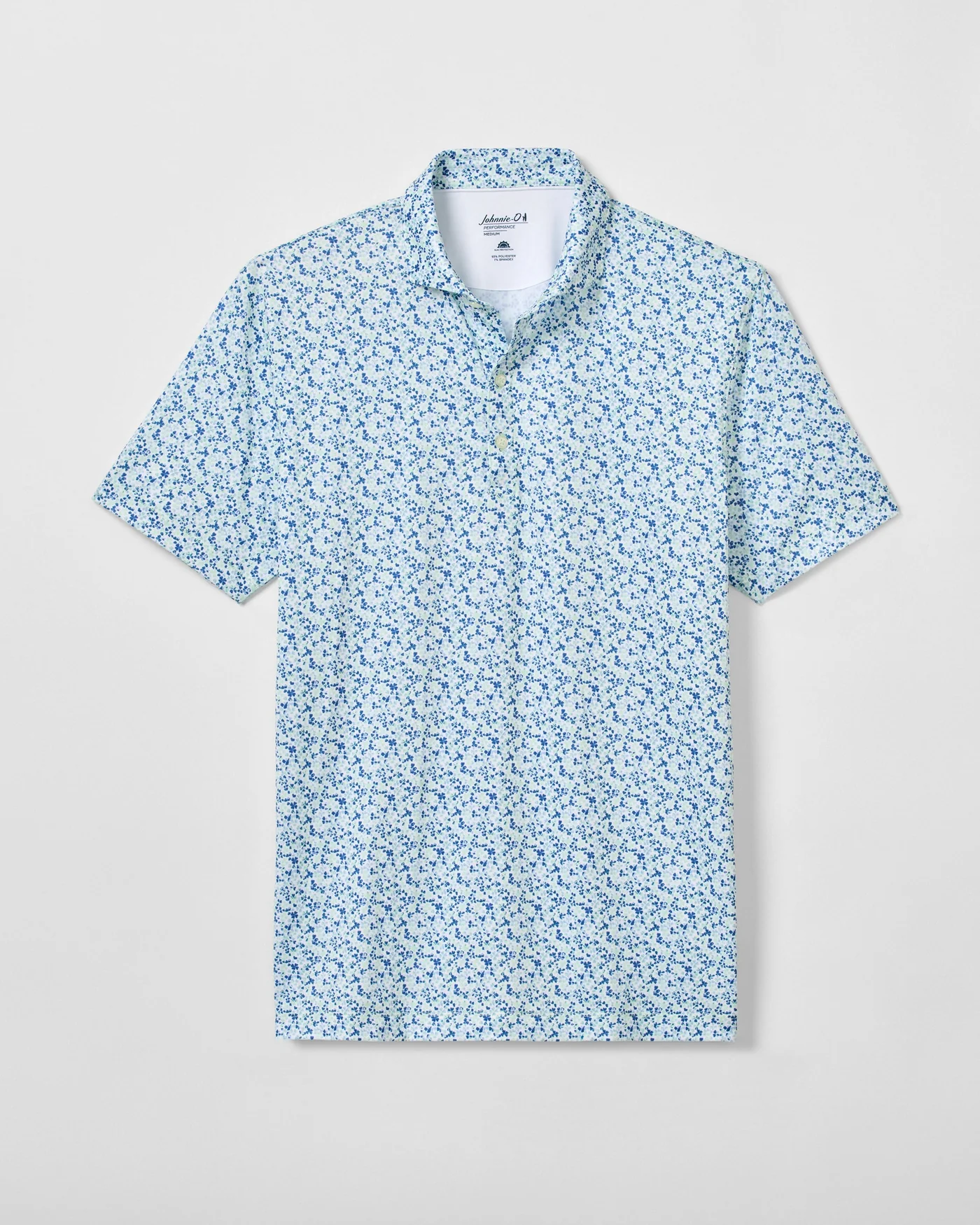 The Johnnie-O Charmer Jersey Polo is a short-sleeve button-up shirt featuring a light blue and white floral pattern, crafted from performance jersey fabric and shown flat against a plain background.