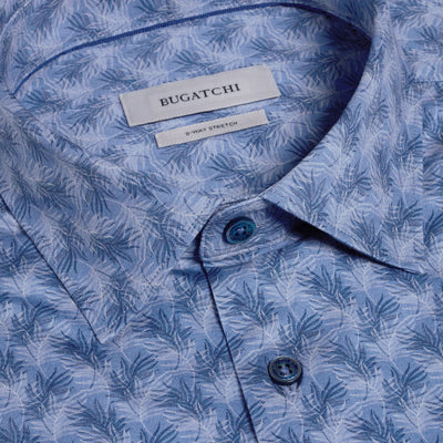 Close-up of the Bugatchi Miles OoohCotton® Leaf Print Shirt JF9138F40, featuring a subtle leaf pattern, collar, two buttons, and a Bugatchi label. Wrinkle-resistant fabric with 8-way stretch ensures all-day comfort.