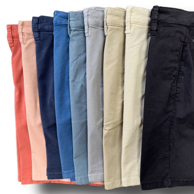 Nine pairs of 34 Heritage Nevada Soft Touch Shorts by 34 Heritage, in slim fit and assorted colors like coral, blue, beige, and black, are arranged side by side in a row.