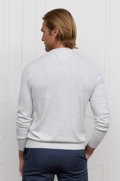 Back view of a man wearing a light grey Raffi Grady Merino Wool & Cotton Diagonal Stitch Crew Neck Sweater HZZ13482 and navy blue trousers.