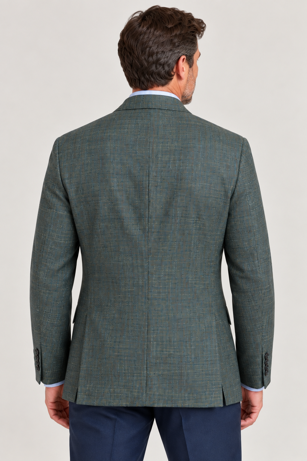 A man, seen from behind and set against a plain light background, is wearing the Hart Schaffner Marx Olive Sport Coat New York Fit (35H0132), crafted from premium Italian fabric, paired with navy pants.