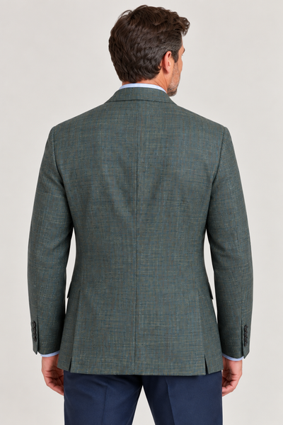 A man, seen from behind and set against a plain light background, is wearing the Hart Schaffner Marx Olive Sport Coat New York Fit (35H0132), crafted from premium Italian fabric, paired with navy pants.