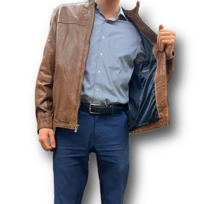A person wearing a blue shirt, navy pants, and the Missani Leather Jacket 392834 stands with the open jacket revealing its inner lining.