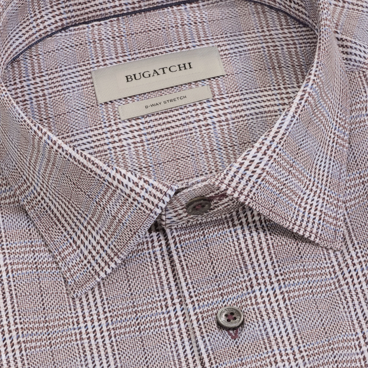 Close-up of the Bugatchi James Plaid Sport Shirt KF9278K60 showcasing a brown and white plaid pattern, a visible Bugatchi brand label, and two buttons—this wrinkle-resistant sport shirt blends comfort with modern style.