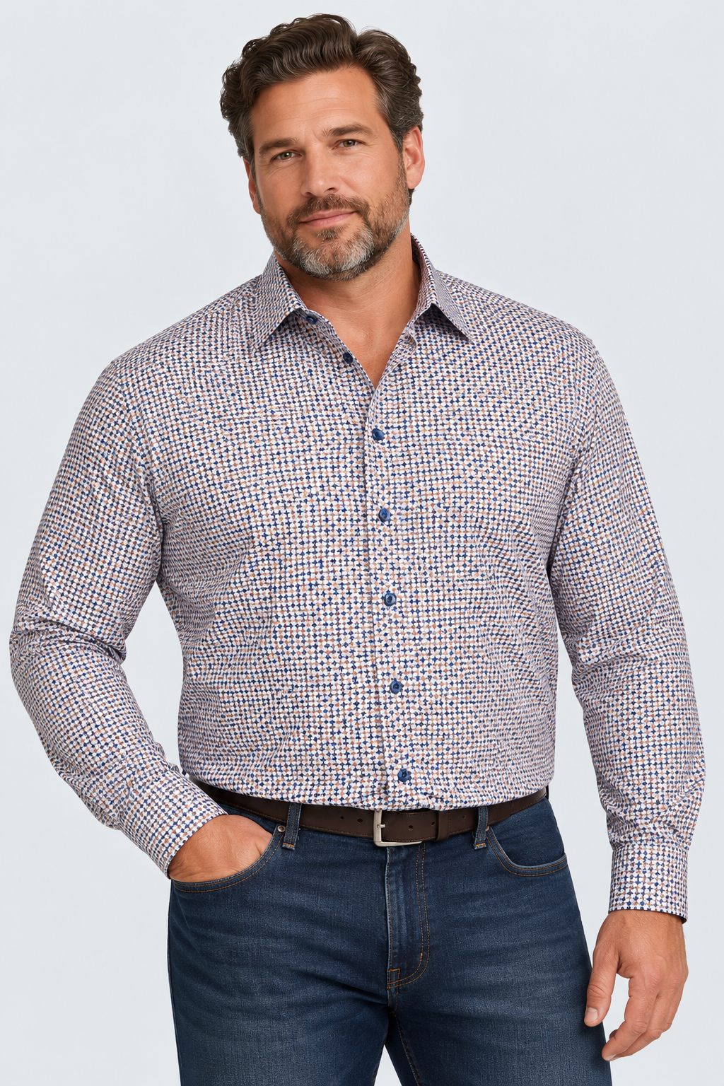A man wears a 7 Downie St. Chevron Navy & White Sport Shirt Big&Tall 26021 with a small geometric pattern, tucked into dark blue jeans with a brown leather belt.