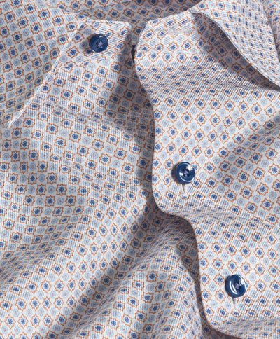 Close-up of the David Donahue Geometric Print Sport Shirt (CHBD10605), featuring a twill weave in US Pima cotton with blue and orange geometric shapes and blue buttons on the patterned fabric.