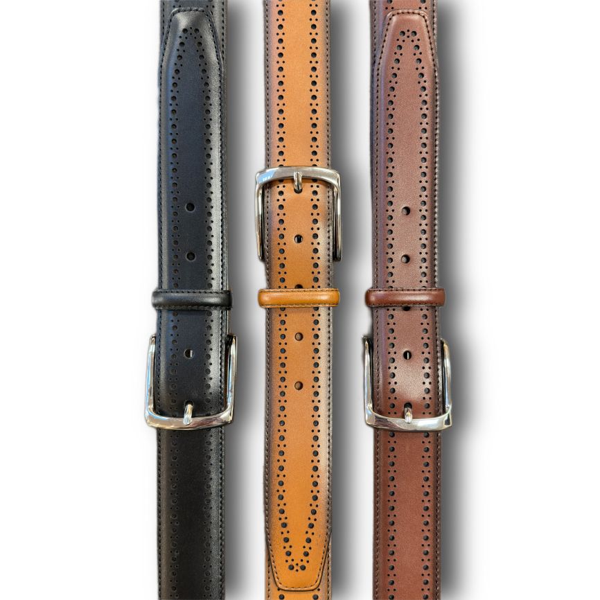 Three Allen Edmonds Manistee Belts in black, tan, and brown leather with silver buckles and brogue detailing are displayed vertically side by side.