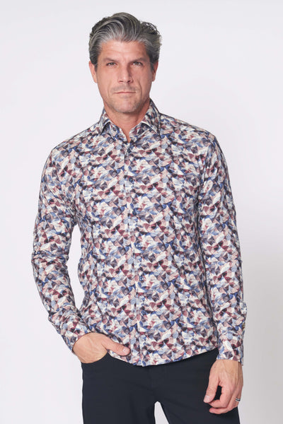 A man stands against a plain background wearing the 7 Downie St Amore Big & Tall Sport Shirt Multi with a tailored fit and black pants, one hand in his pocket.