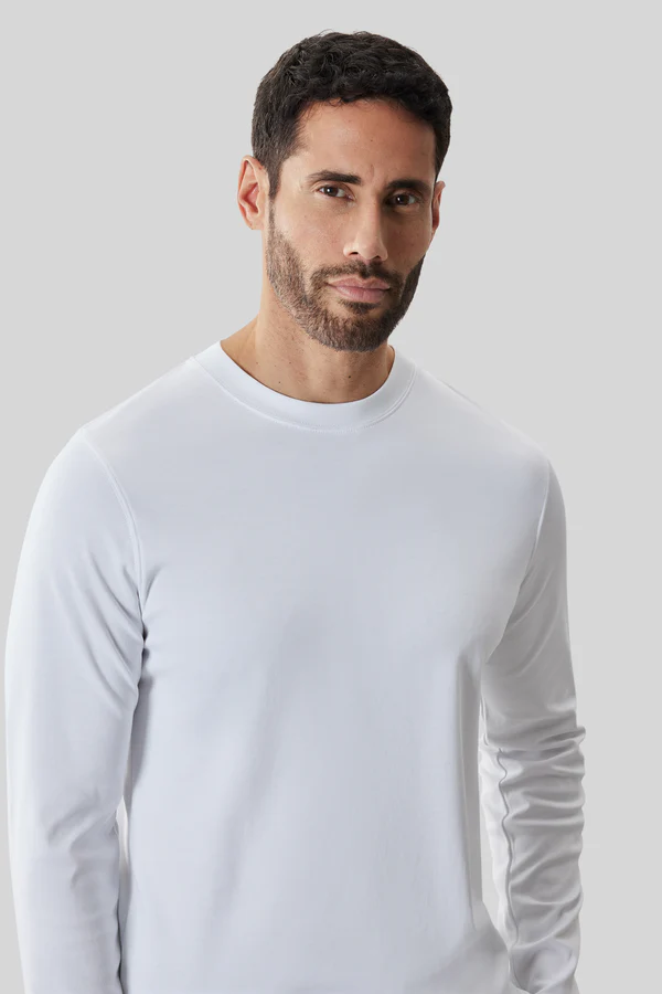 Man with short dark hair and beard wears a dressy white Robert Barakett High Crew Long Sleeve RB82247 T-shirt, standing against a light gray background.