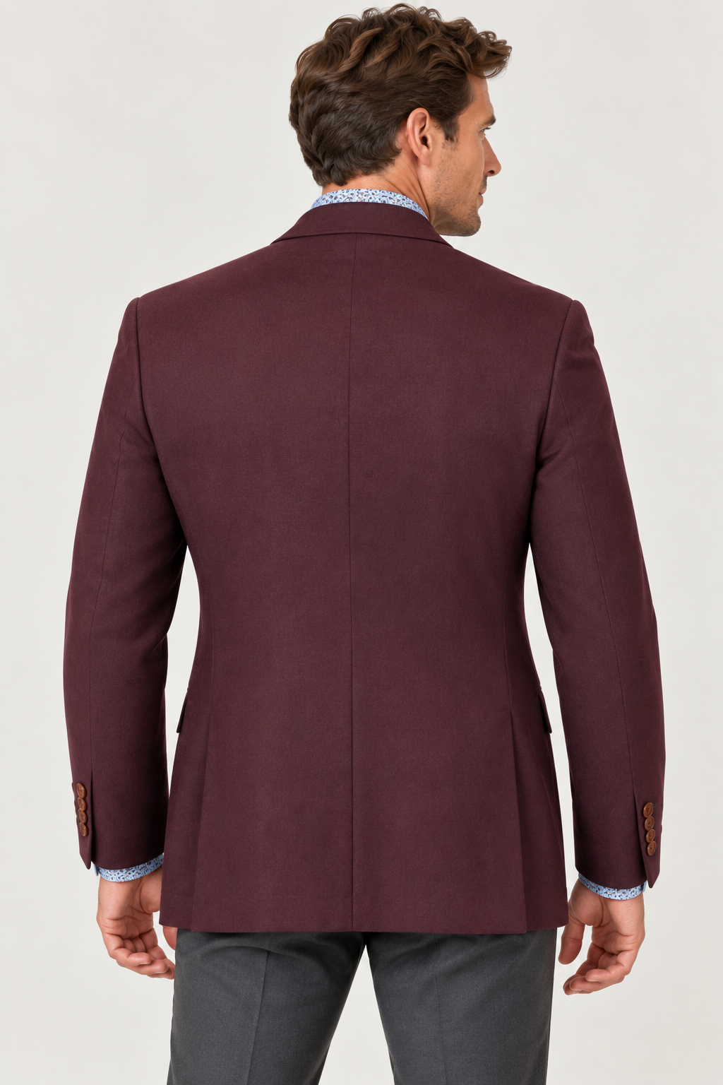 Back view of a man wearing a MaxDavoli Burgundy Cashmere Blend Sport Coat MD86351 over a patterned light blue shirt and grey trousers.