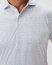 Close-up of a person wearing the Johnnie-O Marietta Big & Tall Knit Polo, a light, featherweight shirt with a small floral print, three-button collar, and UPF 50 sun protection for comfort and style by Johnnie-O.
