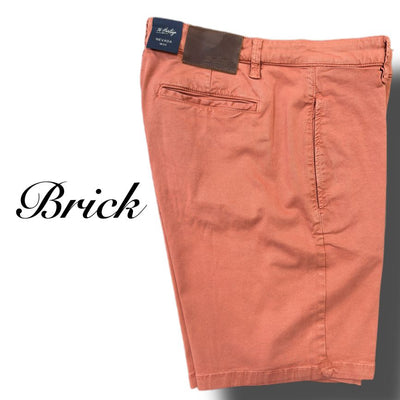 34 Heritage Nevada Soft Touch Shorts in brick, featuring a slim fit, back pocket, and dark brown leather patch on the waistband. Displayed flat on a white background with "Brick" on the left. Made from Soft Touch fabric for comfort.