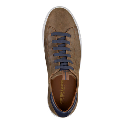 The Johnston Murphy Anson is a brown full grain leather sneaker with dark blue laces and a white sole. Viewed from above, the insole is branded and features a cushioned EVA outsole for comfort.
