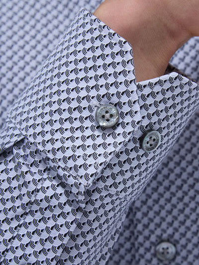 Close-up of the Bugatchi LS Devon GF9025K80 Platinum shirt cuff, showcasing a black-and-white geometric pattern, two grey buttons, and part of a wrist—a refined detail reflecting Bugatchi's Italian craftsmanship and premium fabrics.