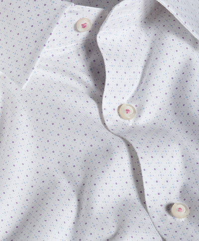 Close-up of the David Donahue Stretch Print Dress Shirt TBSP13200, a white Oxford weave shirt with subtle purple dots and cream buttons, showcasing a gently wrinkled texture and unbuttoned collar—a refined piece from David Donahue.