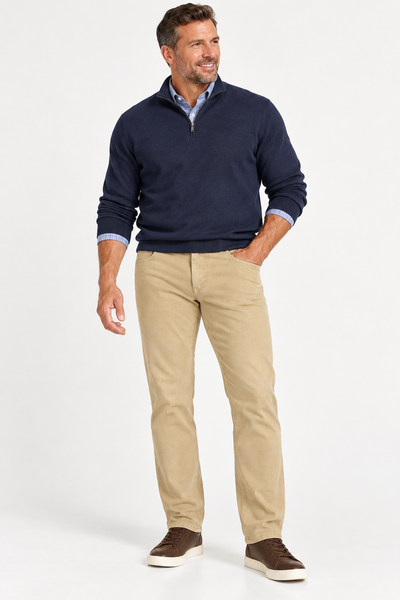 Man smiling in a navy pullover, blue shirt, tan pants, and brown sneakers—ideal to pair with Alberto PIPE 1607 Diamond Brushed Stretch Cotton Jeans from Alberto.