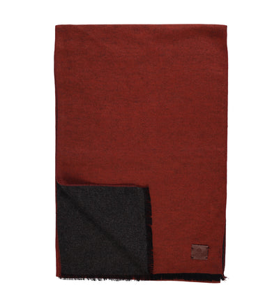 The Amanda Christensen Double Face Scarf 440714 by Amanda Christensen features rust-red and dark gray sides, a small brown leather patch in one corner, and elegant fringed edges.