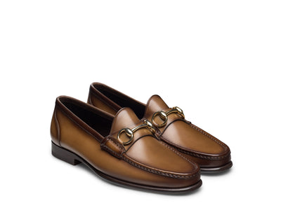 Magnanni Giancarlo Moc Toe Bit Loafers by Magnanni feature brown leather construction, gold metal bit detailing, a low heel, and hand-stitched accents around the toe.