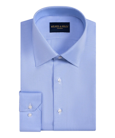 A neatly folded light blue Wilkes & Riley Queens Classic B&T dress shirt with buttoned cuffs is displayed on a white background.