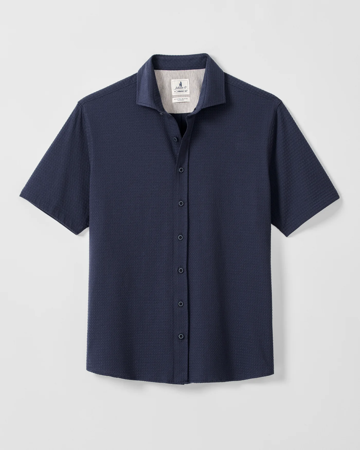 Enhance your style with the Johnnie-O Surfsucker Knit Short Sleeve Button Down Shirt, a navy blue textured piece featuring a spread collar and white inner label, shown on a plain white background.
