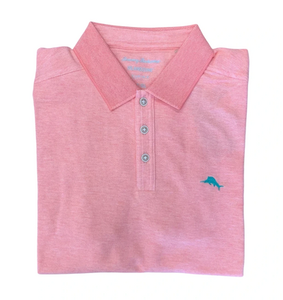 The Tommy Bahama Emfielder Island Zone Polo Big & Tall is a light pink polo with a collar, three buttons, and a blue embroidered dolphin logo, made from moisture-wicking Supima cotton for all-day comfort.